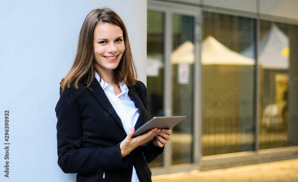 Smiling businesswoman using a digital tablet outdoor Smiling businesswoman using a digital tablet outdoor