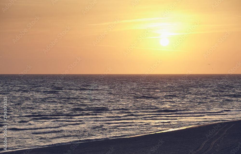 Scenic sunrise over the sea, color toned picture.
