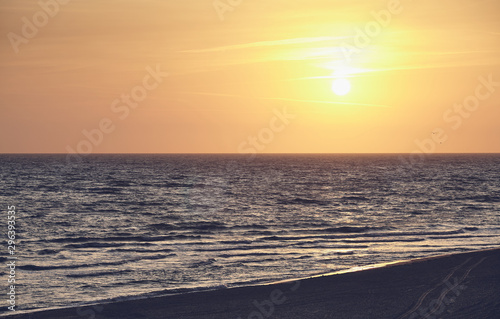 Scenic sunrise over the sea, color toned picture.