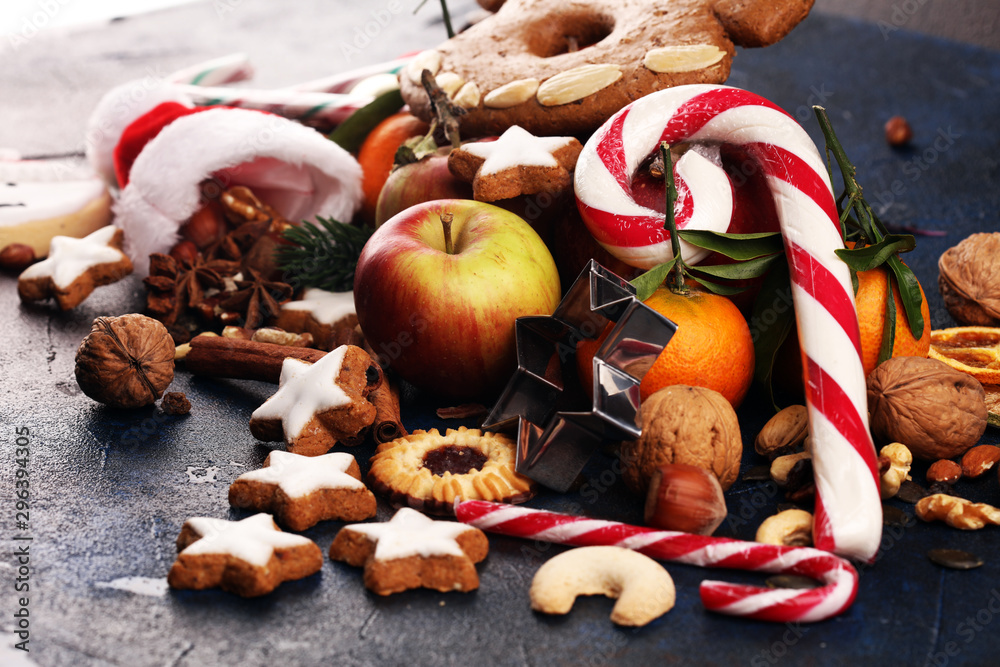 christmas cookies and santa had with spieses, nuts and fruits on rustic table