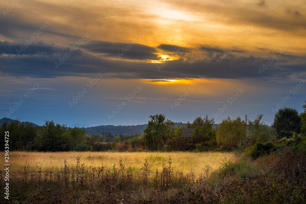 Meadow and fields in autumn at sunset