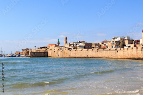 Fototapeta Naklejka Na Ścianę i Meble -  Coastline panorama of Acre Old City with seawall and marina at mediterranean sea, Israel