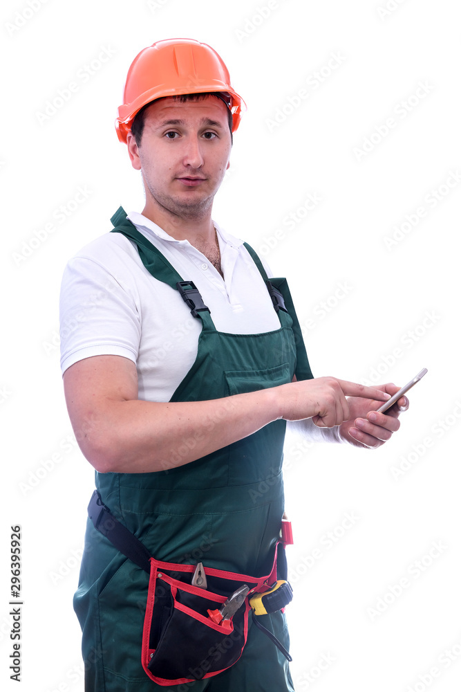 Builder in coverall holding mobile phone isolated on white