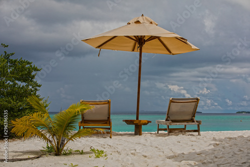 parasol and chairs on the beach of hanimaadhoo  maldives 