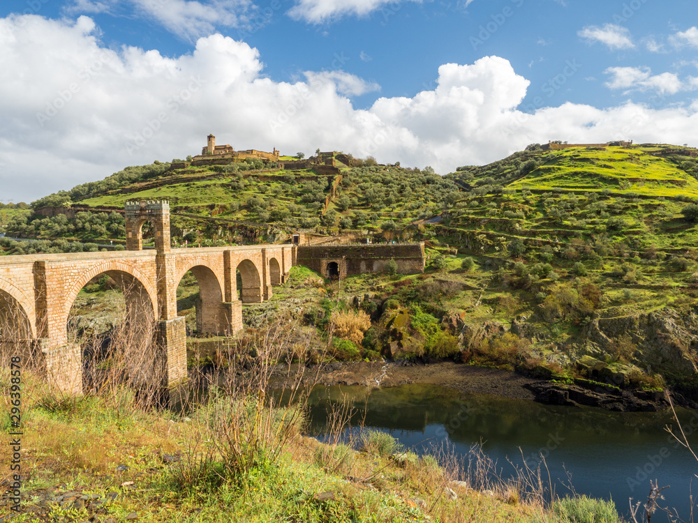 The Puente de Alcantara, a Roman arch bridge in Toledo, Catile-La Mancha, Spain, spanning the Tagus River. The word comes from Arabic bridge