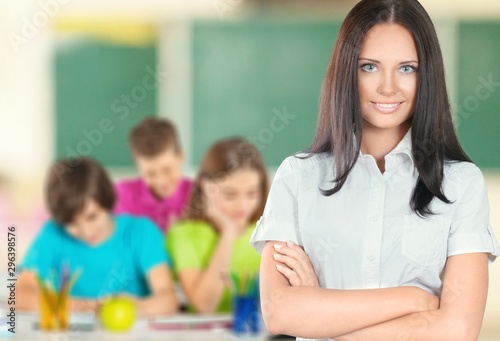 Young female teacher with students in classroom