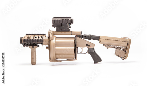 Tan grenade launcher facing right in studio on white background.