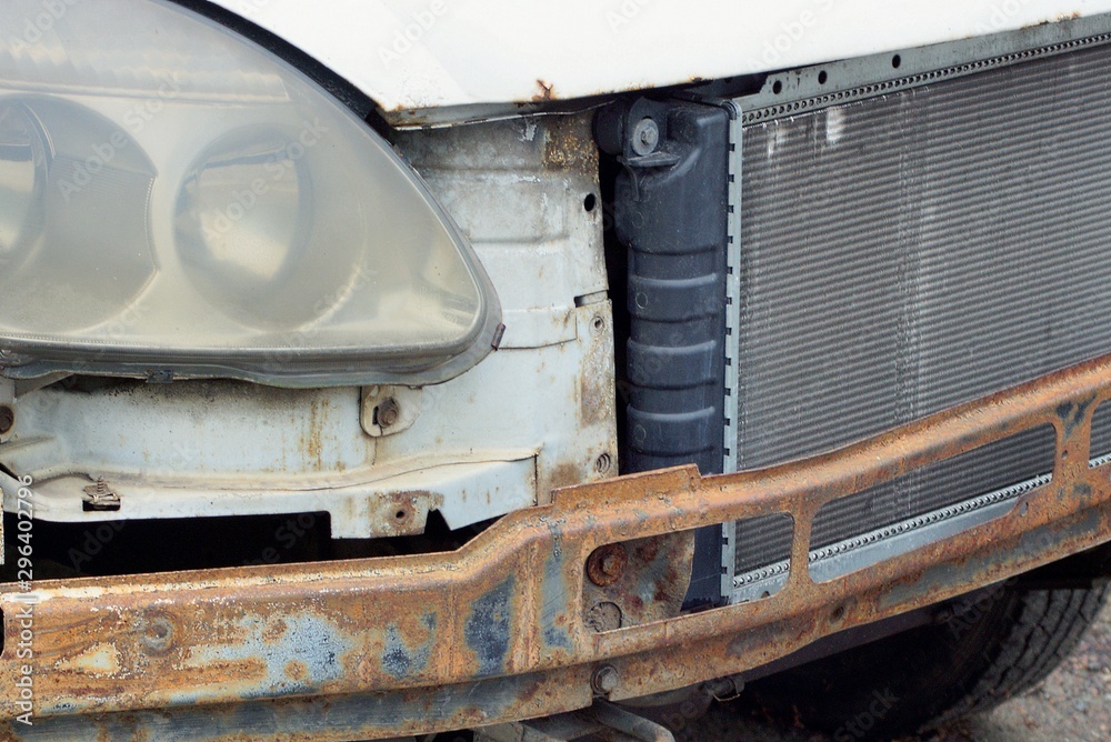crashed car with a radiator and headlight on the street crashed car with a radiator and headlight on the street