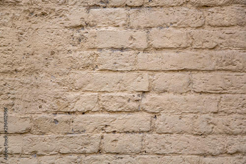 old gray beige brick wall with damaged cement. rough surface texture
