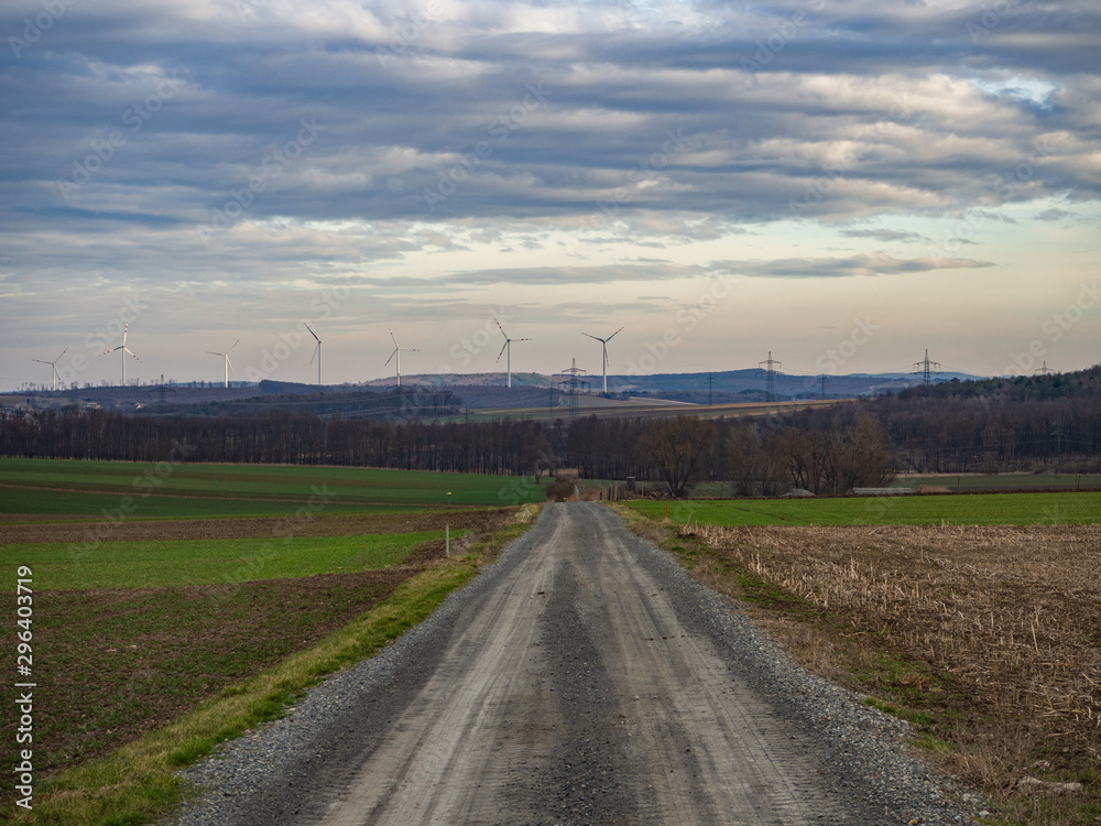 Country road and agriculture fields on cloudy day