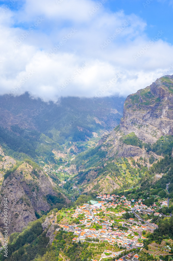 Breathtaking Curral das Freiras, known as Valley of the Nuns in Portuguese Madeira. Small village surrounded by rocks and mountains. Portuguese landscape. Clouds in the valley. Tourist attraction