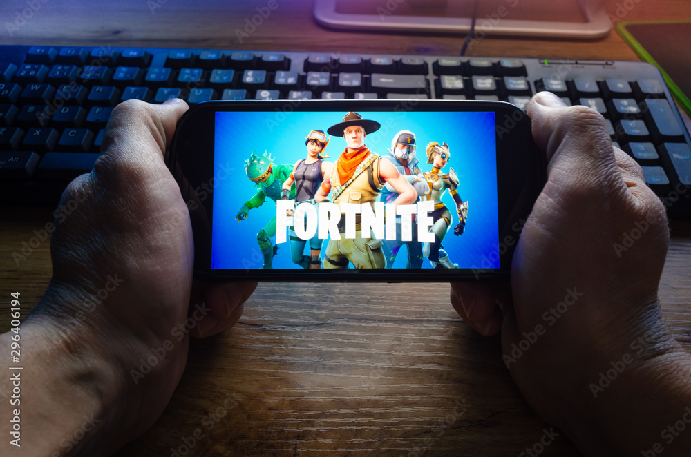 Kostanay, Kazakhstan, January 29, 2019.Person looks at the screen saver of  the popular game Fortnite from Epic Games on Mobile. Stock Photo | Adobe  Stock