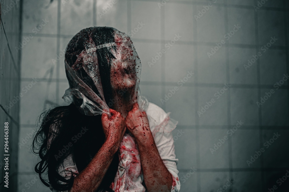 A woman is brutally murdered by a bag over her head. Feeling tortured and needing help, Halloween murder concept.