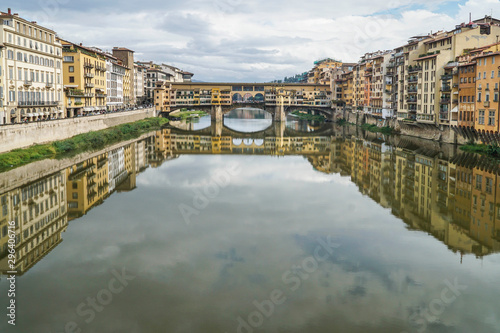 reflection of bridge and buildings on river in Florence, Italy