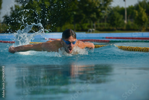 Swimmer standing next to a pool on a sunny morning