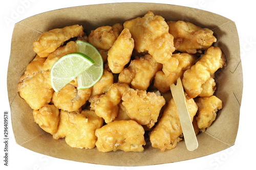 Kibbeling in a cardboard tray isolated on white background. Kibbeling is a Dutch snack consisting of battered chunks of fish. It is a very popular dish in the Netherlands.