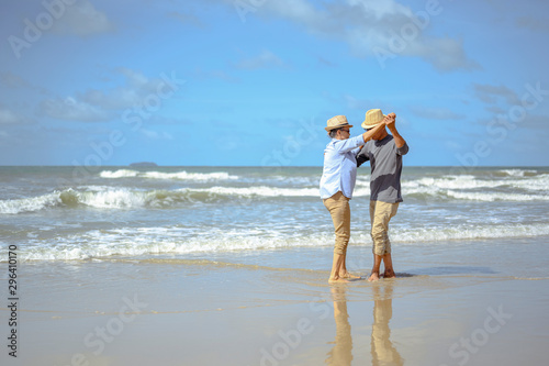 Senior couple  dancing on the beach on good days, plan life insurance at retirement concept.