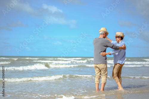 Senior couple  dancing on the beach on good days, plan life insurance at retirement concept.
