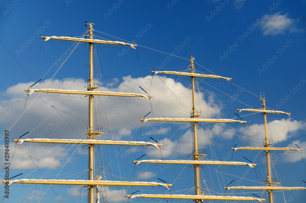 the mast of a sailboat against a blue sky. the mast of a sailboat against a blue sky.