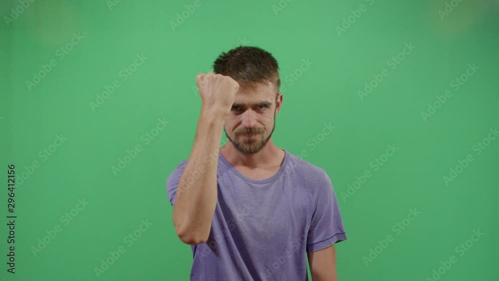 Adult Man Protesting Making A Tight Fist Sing. Studio Isolated Shot Against Green Screen Background Adult Man Protesting Making A Tight Fist Sing. Studio Isolated Shot Against Green Screen Background