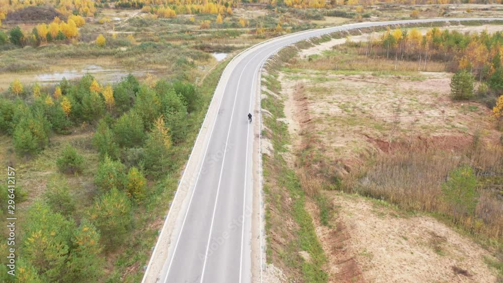 Man on the road cycling aerial. Cyclist on the road. Man on the road cycling aerial. Cyclist on the road.