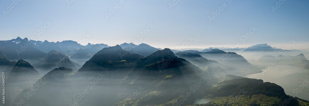 Panoramic view on hazy Swiss Alps and Lake Lucerne as seen from top of Fronalpstock close to Stoos village - obrazy, fototapety, plakaty 
