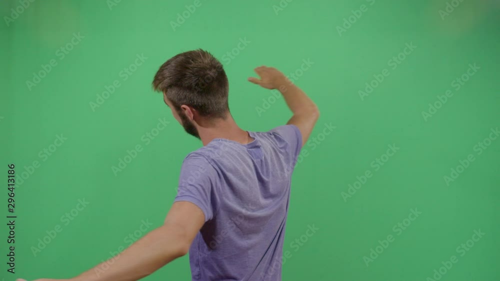 Adult Man Spinning With His Hands Spread Out. Studio Isolated Shot Against Green Screen Background Adult Man Spinning With His Hands Spread Out. Studio Isolated Shot Against Green Screen Background
