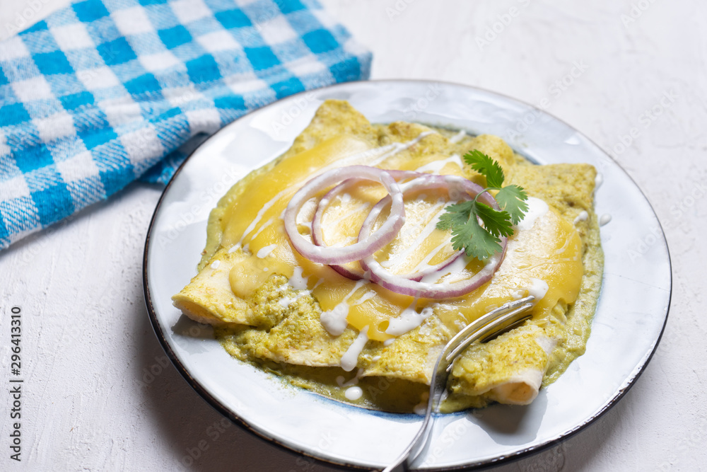 Mexican green enchiladas with melted cheese also called Mexican green enchiladas with melted cheese also called