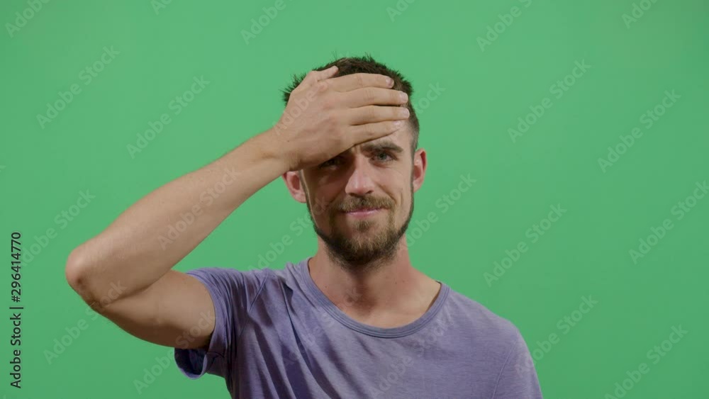 Adult Man Slapping His Forehead Suggesting Bad News Notice. Studio Isolated Shot Against Green Screen Background