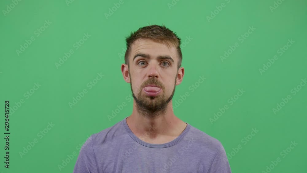 Funny Pose Tongue Farting By A Adult Man. Studio Isolated Shot Against Green Screen Background