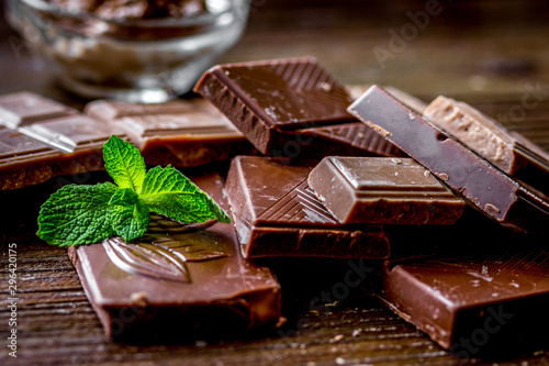 chocolate pieces with mint on wooden table background