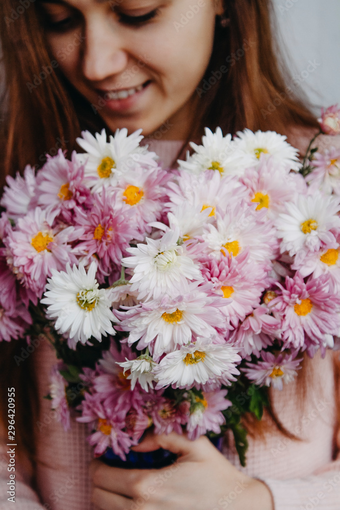 Bouquet of chrysanthemums in female hands close-up Bouquet of chrysanthemums in female hands close-up