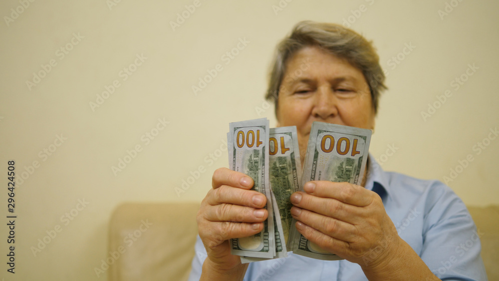 Old woman counting money, grandmother hands with dollars and pensioner face Old woman counting money, grandmother hands with dollars and pensioner face