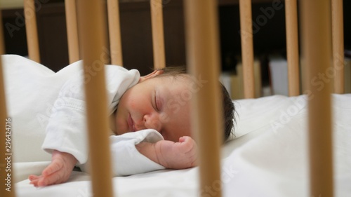 Newborn sleeping a child bed, peaceful baby nap, moving view