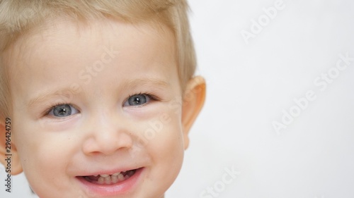 Child portrait  blond hair and blue eyes kid looking and smiling to camera