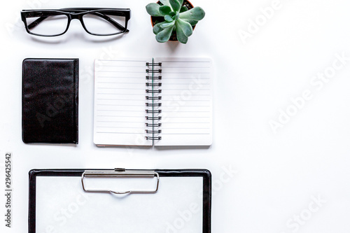 office flat lay with keyboard, wallet, notebook on white background top view mockup photo