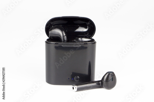 Black wireless headphones with box on a white background..Bluetooth headphone with charger.