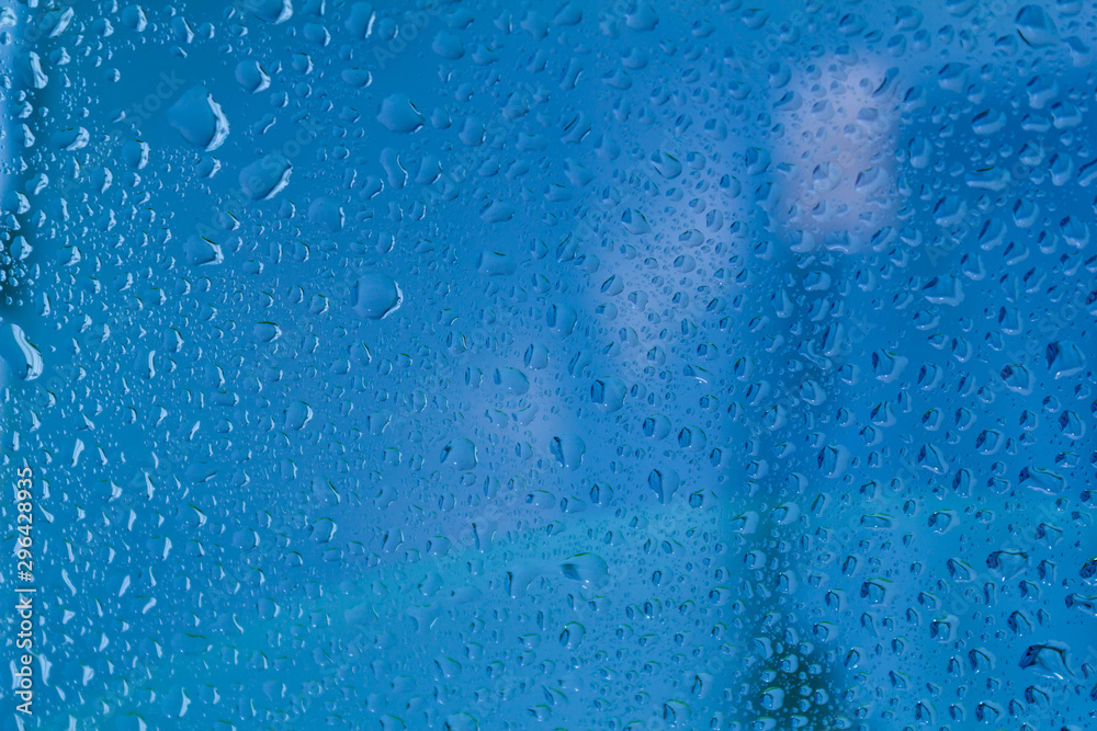 Raindrops on the surface of window panes Natural pattern of raindrops, on a blue background. Raindrops on the surface of window panes Natural pattern of raindrops, on a blue background.