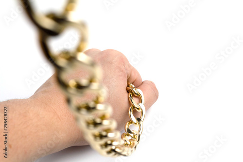 Golden chain in hands on a white background isolate