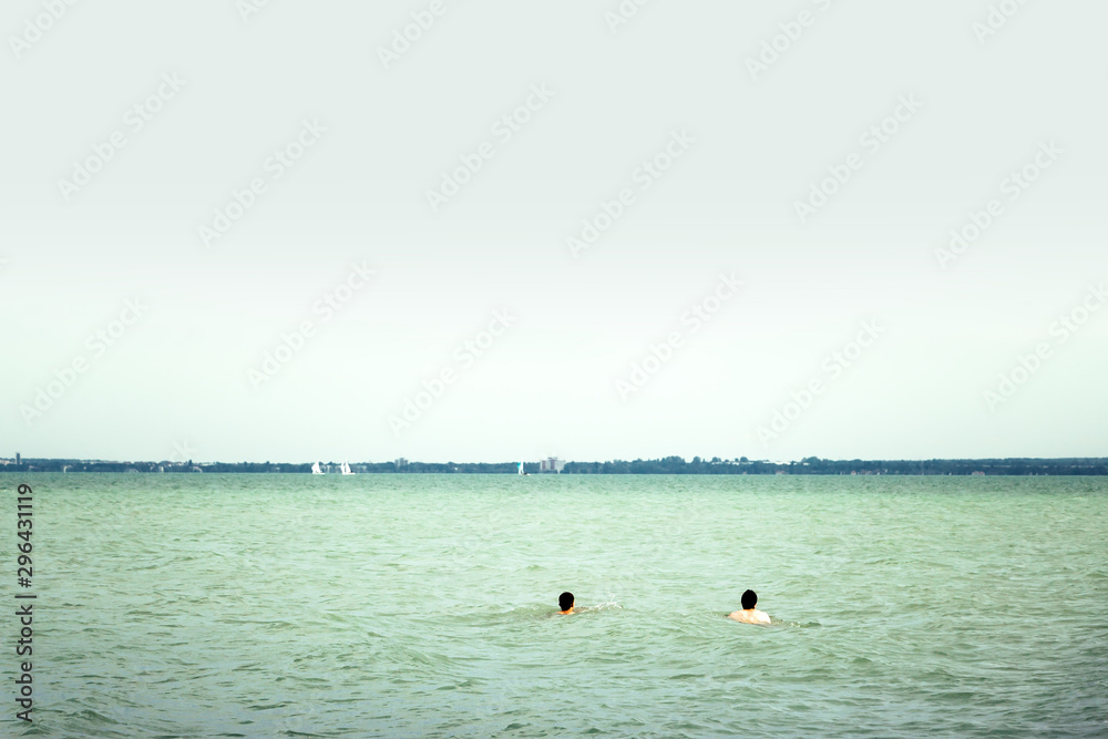 Panoramic view of the Lake Balaton with two swimmwers. Balaton is the largest  lake in Central Europe and a famous tourist destination in Hungary. Stock  Photo | Adobe Stock