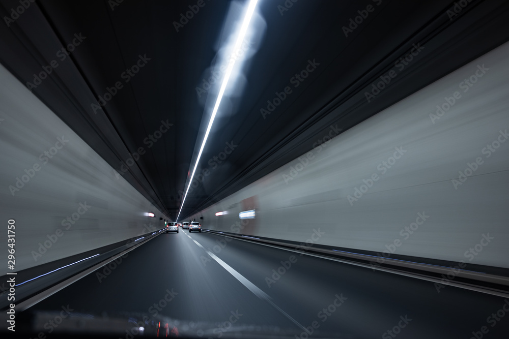 Cars on a highway going through a long modern tunnel (motion blurred image; color toned image) Cars on a highway going through a long modern tunnel (motion blurred image; color toned image)