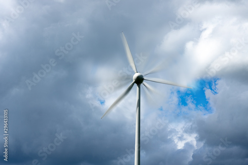 wind turbine windmill with motion blur and cloudy sky