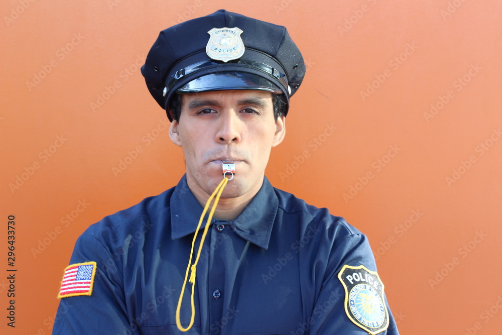 Obraz premium Ethnic American cop blowing a whistle 