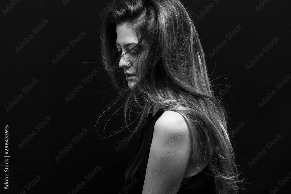 Beautiful girl with makeup and long smooth hair on a black background Beautiful girl with makeup and long smooth hair on a black background