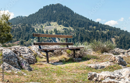 Bench with great view on Mainalo mountain.Vatessiniko village, Greece. photo