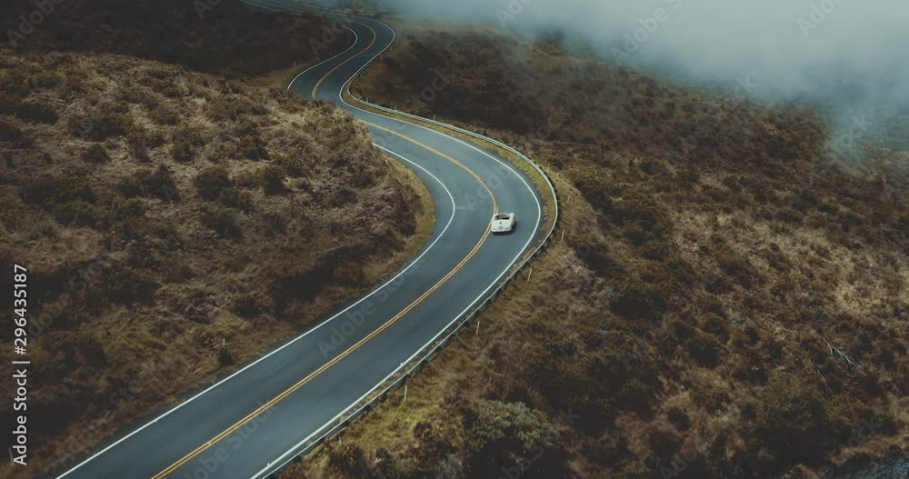 Aerial view following a vintage white convertible