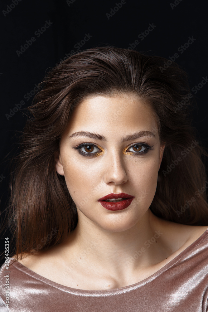 Beauty portrait of a girl with makeup with red lips
