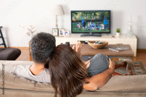 couple watching tv in living room