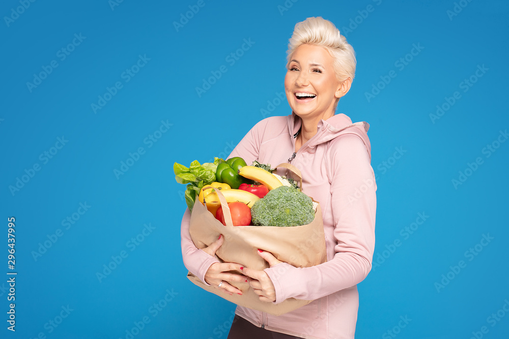 Woman holding shopping bag with healthy food.