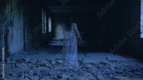 Female ghost walking and disappearing in old abandoned building, spirit of past photo